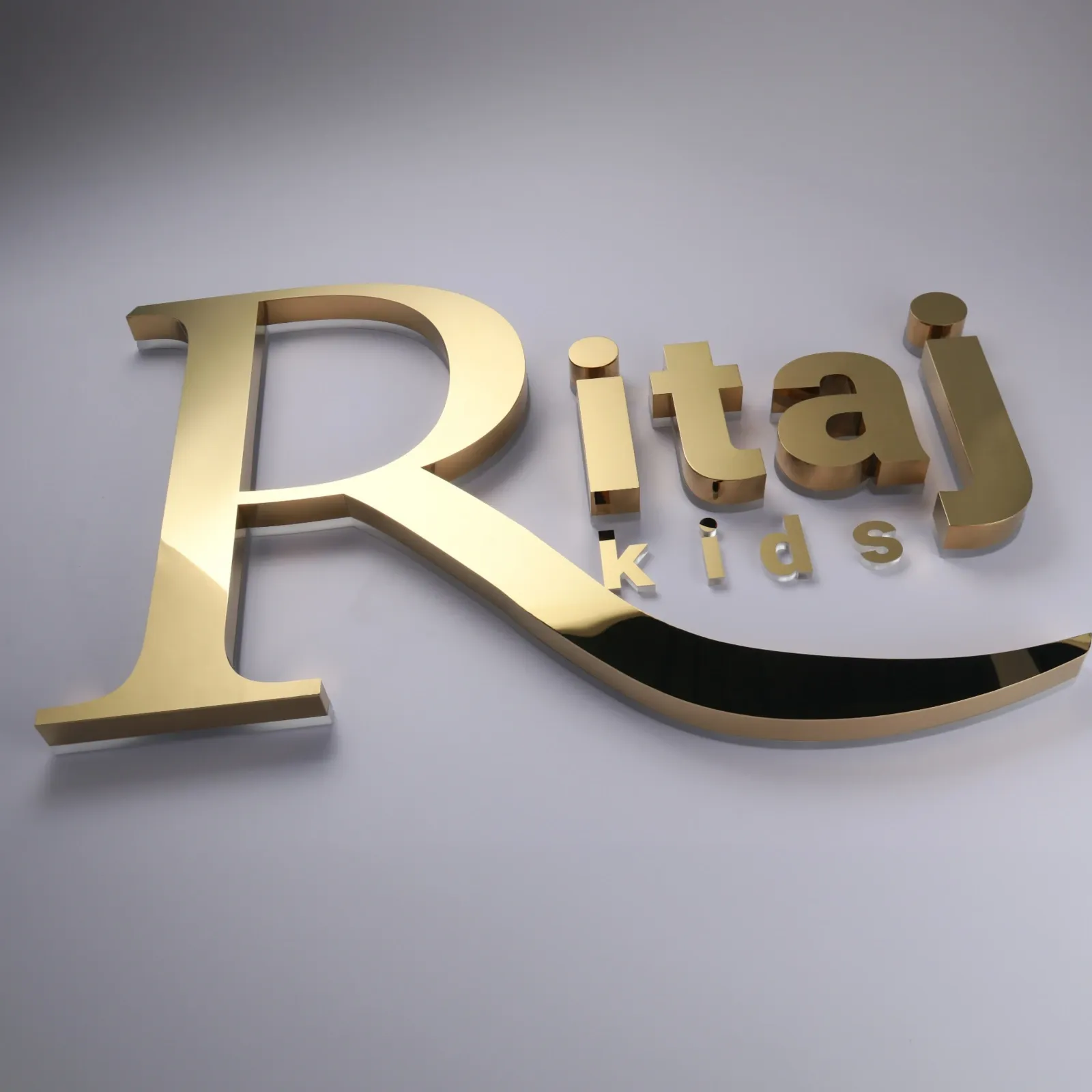 Custom Mirror Titanium Gold Backlit Channel Letters | Halo Lit Stainless Steel Sign